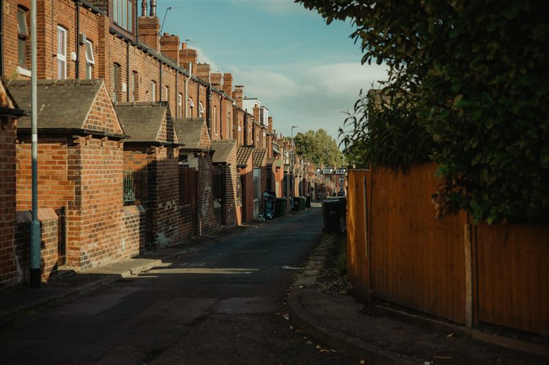Row of red-brick terraced houses on a back street